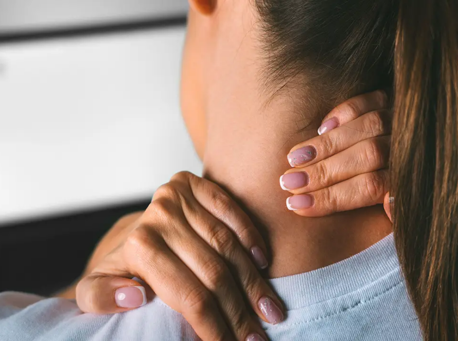 Woman touching the pain points in her neck.