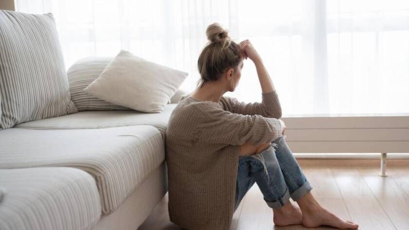 Woman leaning her head on fist while staring at the window