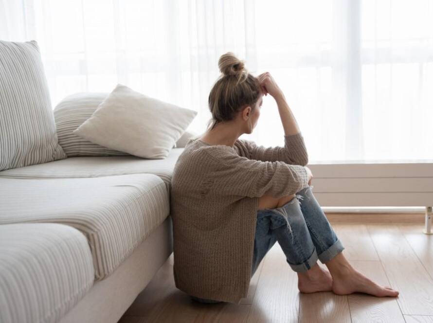 Woman leaning her head on fist while staring at the window