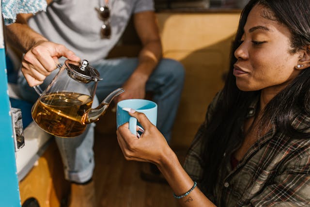 A man pouring tea into a woman's cup
