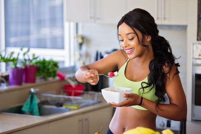 A woman eating from a white bowl
